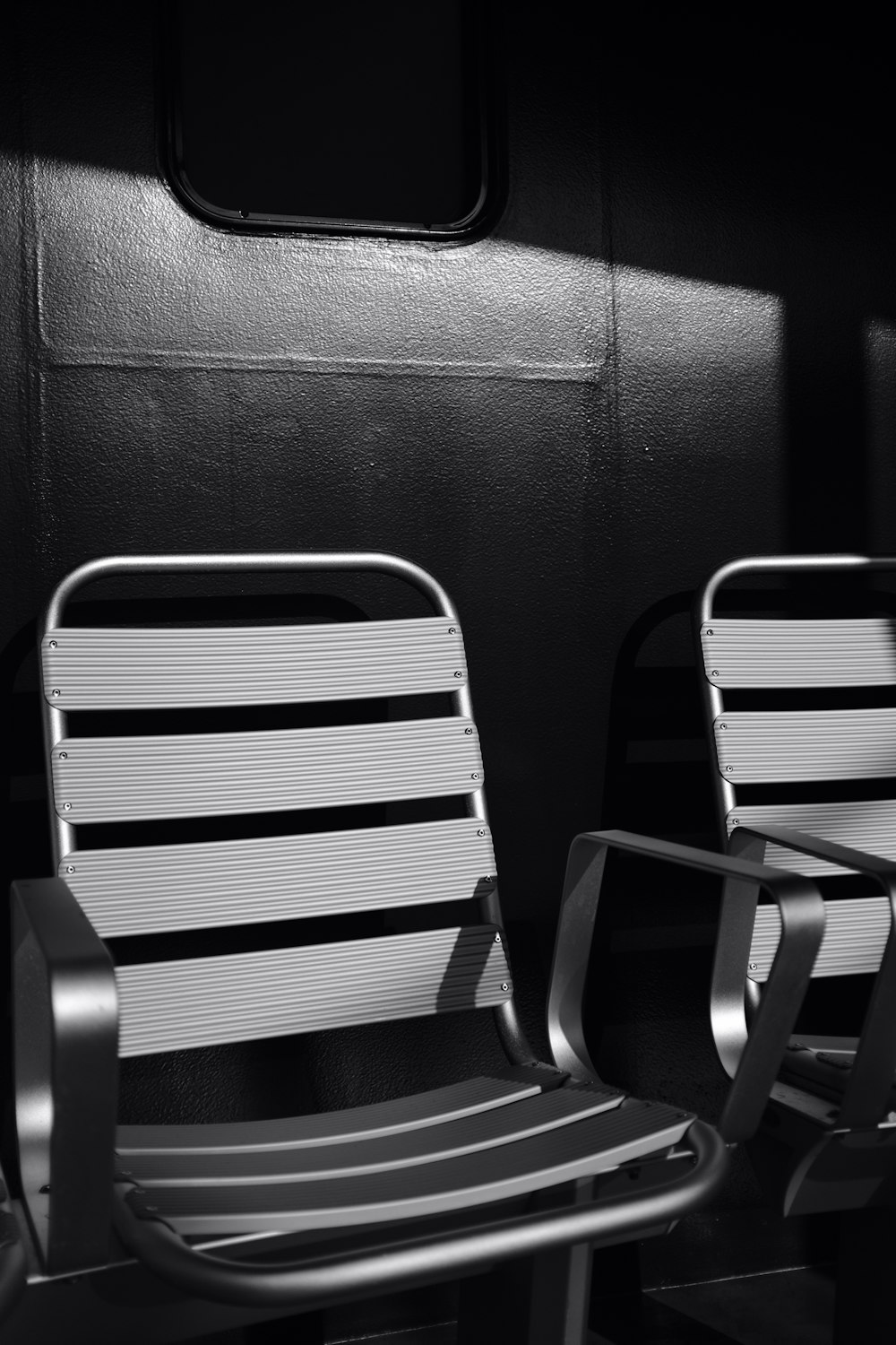grayscale photography of two vacant chairs