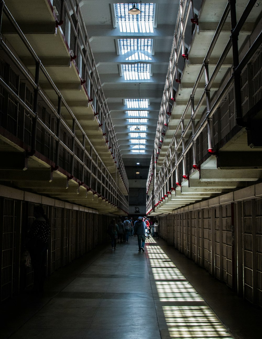 people walking in prison hallway