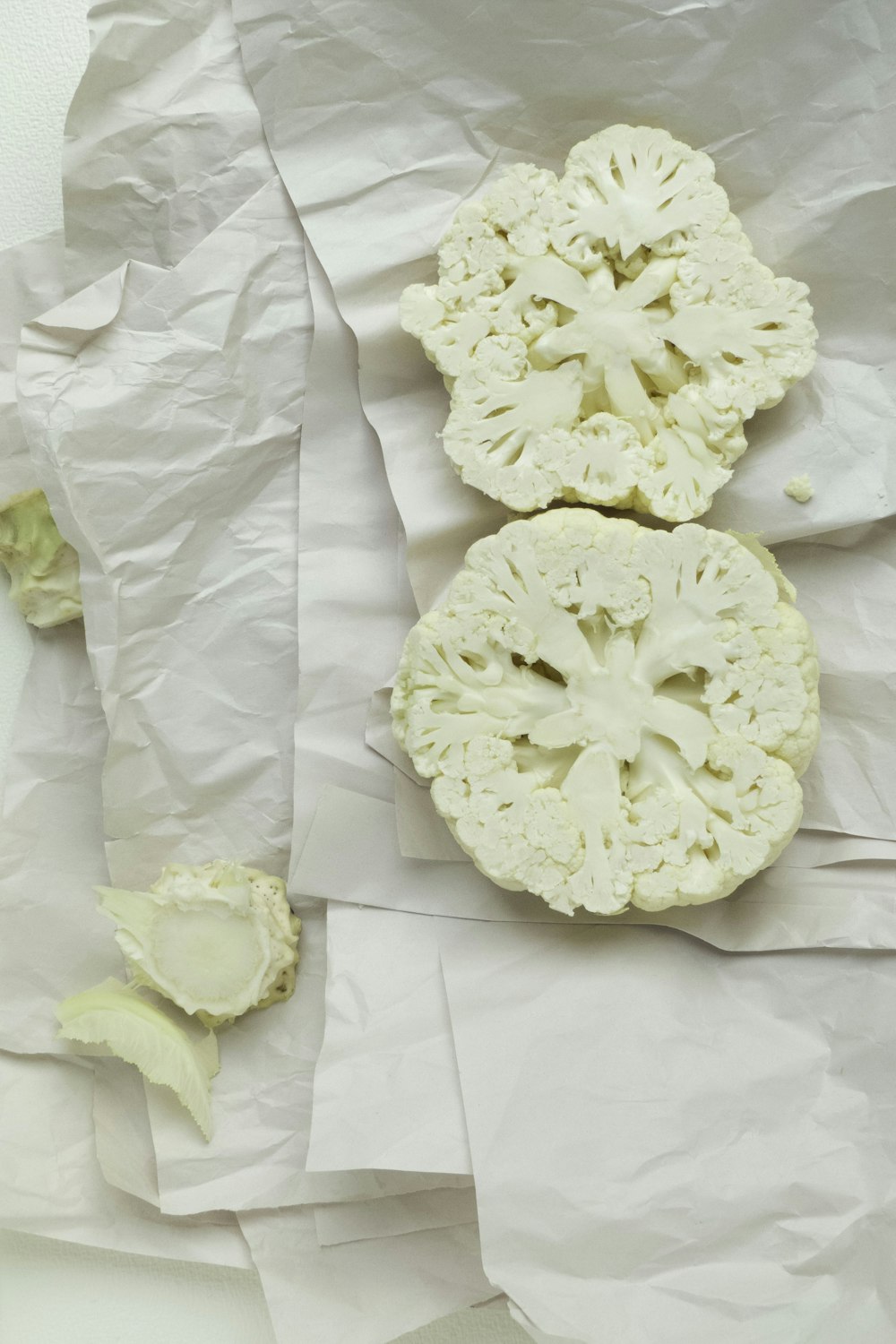 a couple of pieces of broccoli sitting on top of a piece of paper