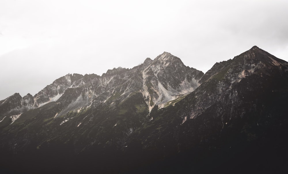 brown mountain under gray sky