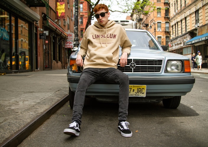 man leaning on car