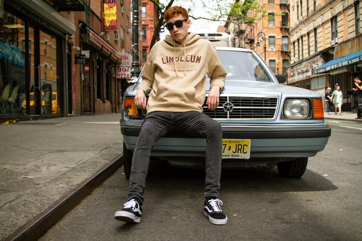 man leaning on car