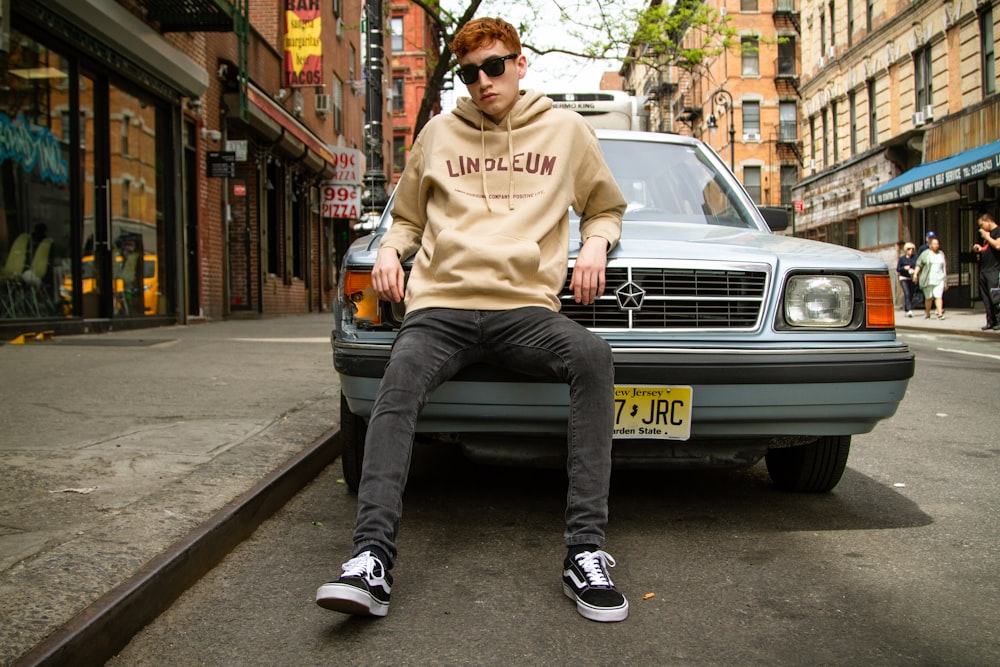 man leaning on car