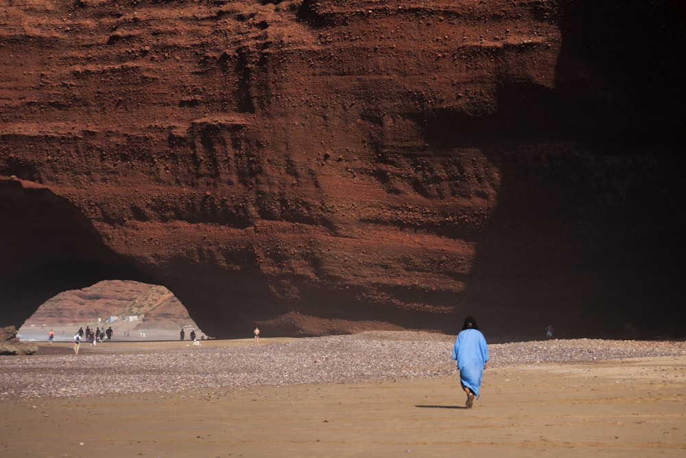 person walking on brown field