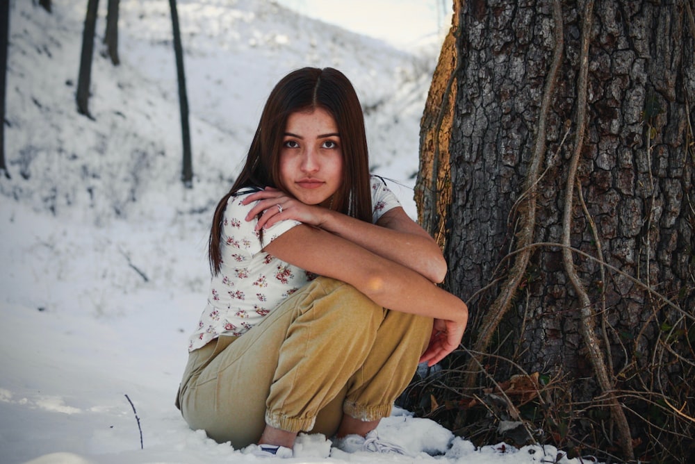 woman sitting beside tree