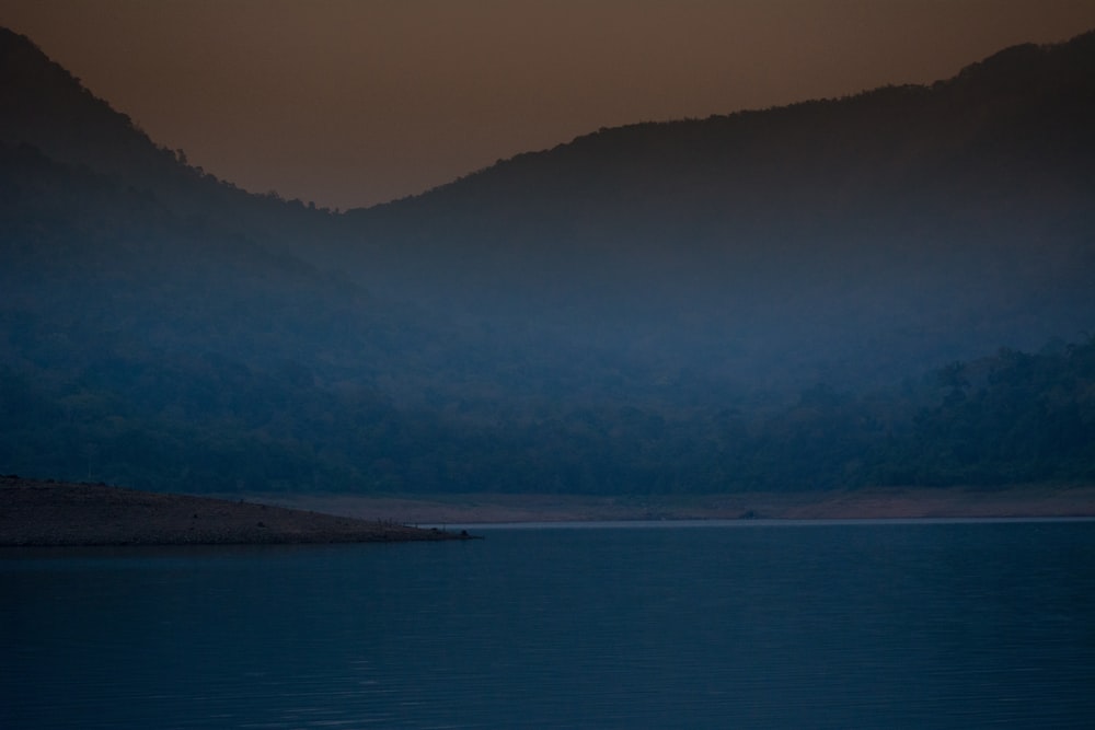 landscape photography of body of water and mountain during nighttime