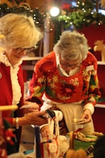 two women checking on Christmas decorations