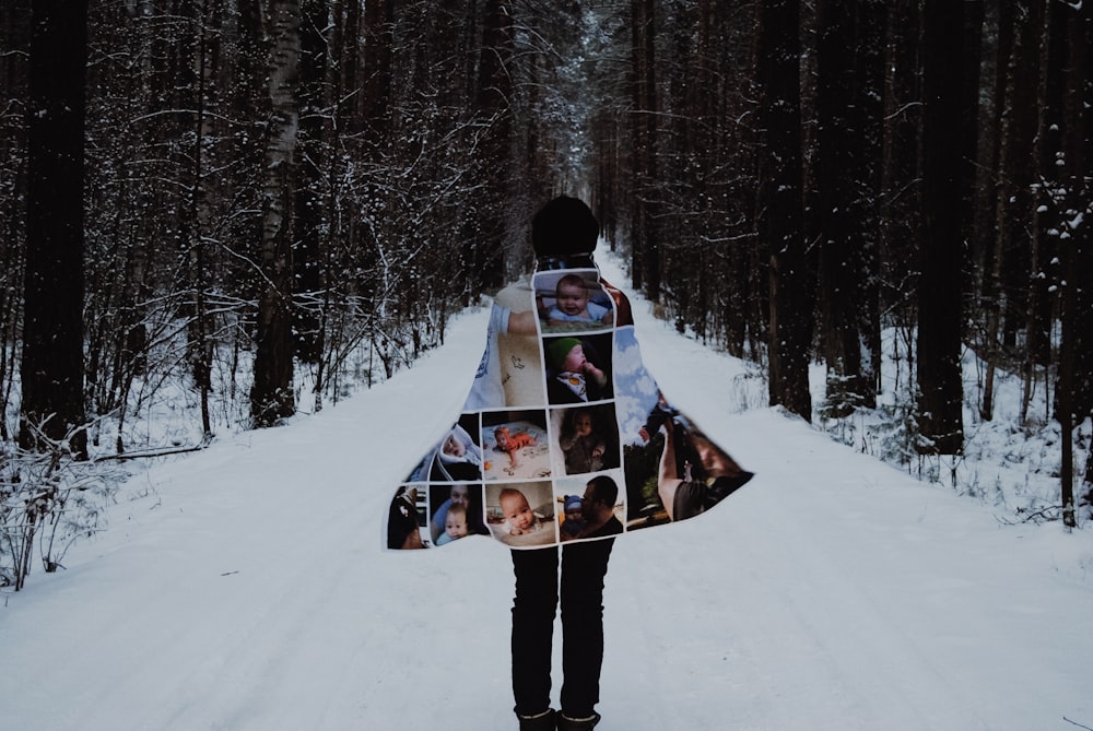 person standing on snow-covered street wearing photo graphic cape