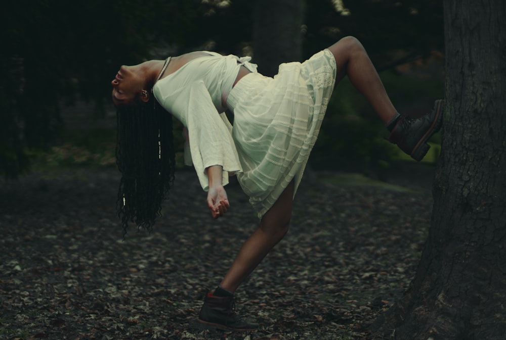 woman bending over tree