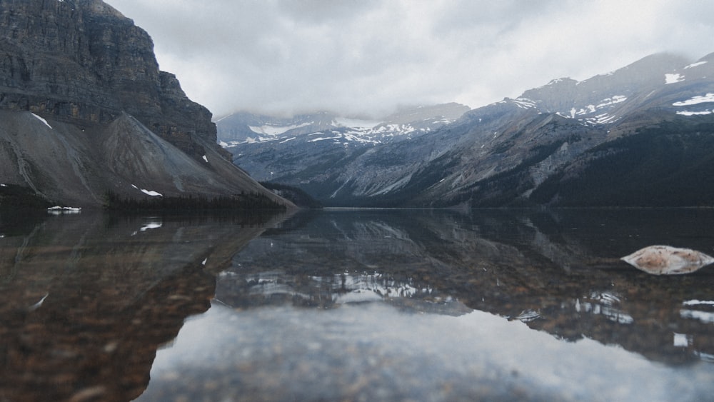 body of water near mountains