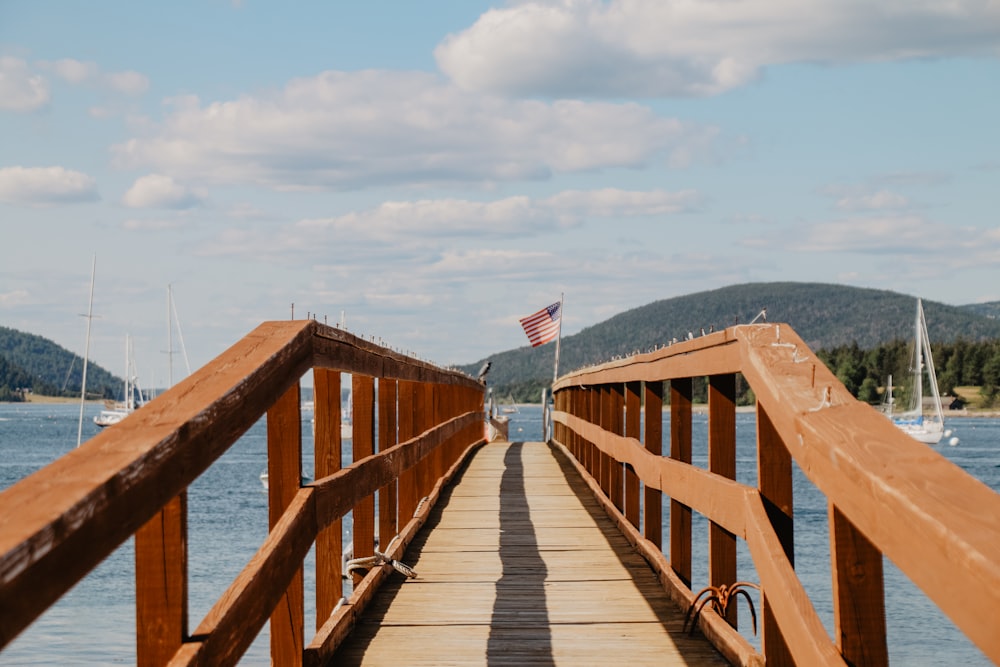 dock with railing near boats during day