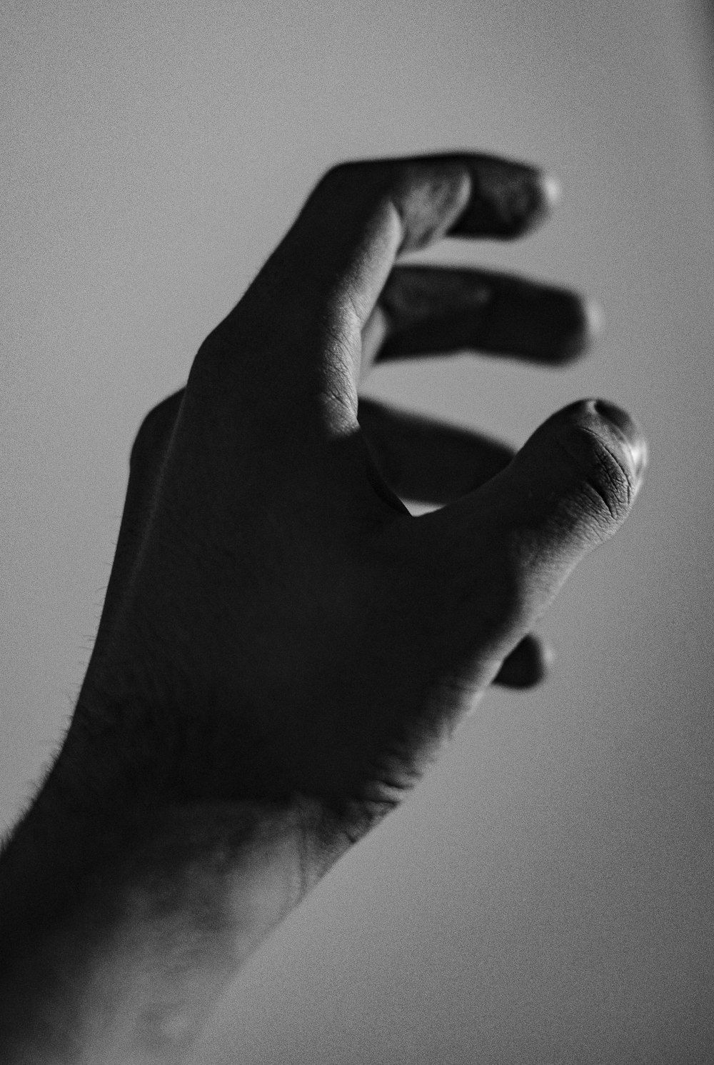 grayscale photography of left hand