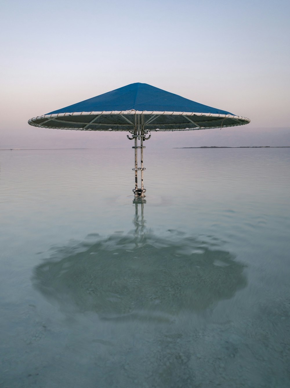 blue and gray patio umbrella in water