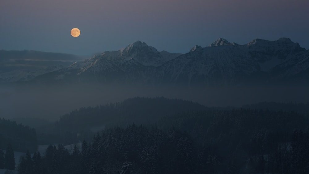 Fotografía aérea de la montaña viendo la luna llena
