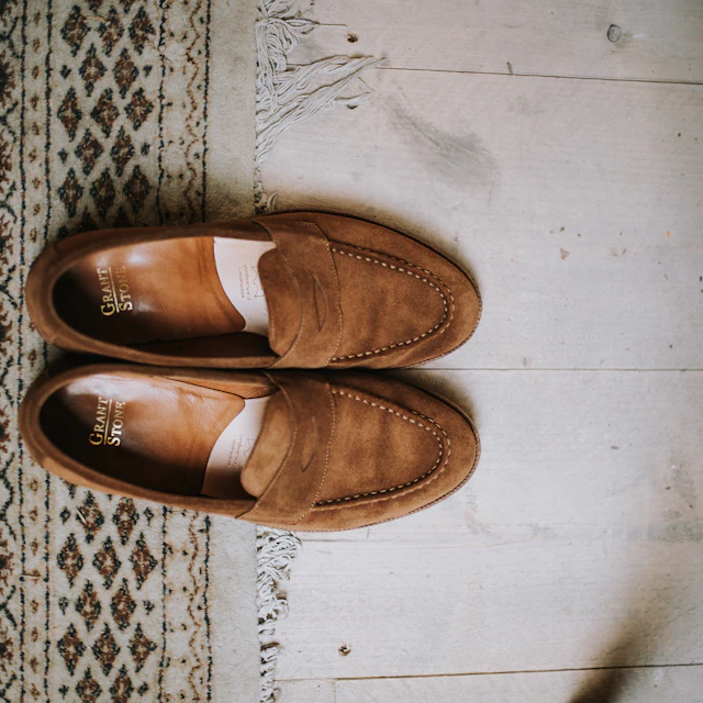 A pair of brown suede penny loafers