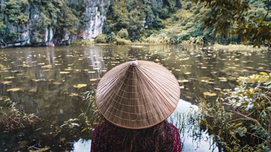 woman wearing brown wicker hat in Ninh Bình Vietnam