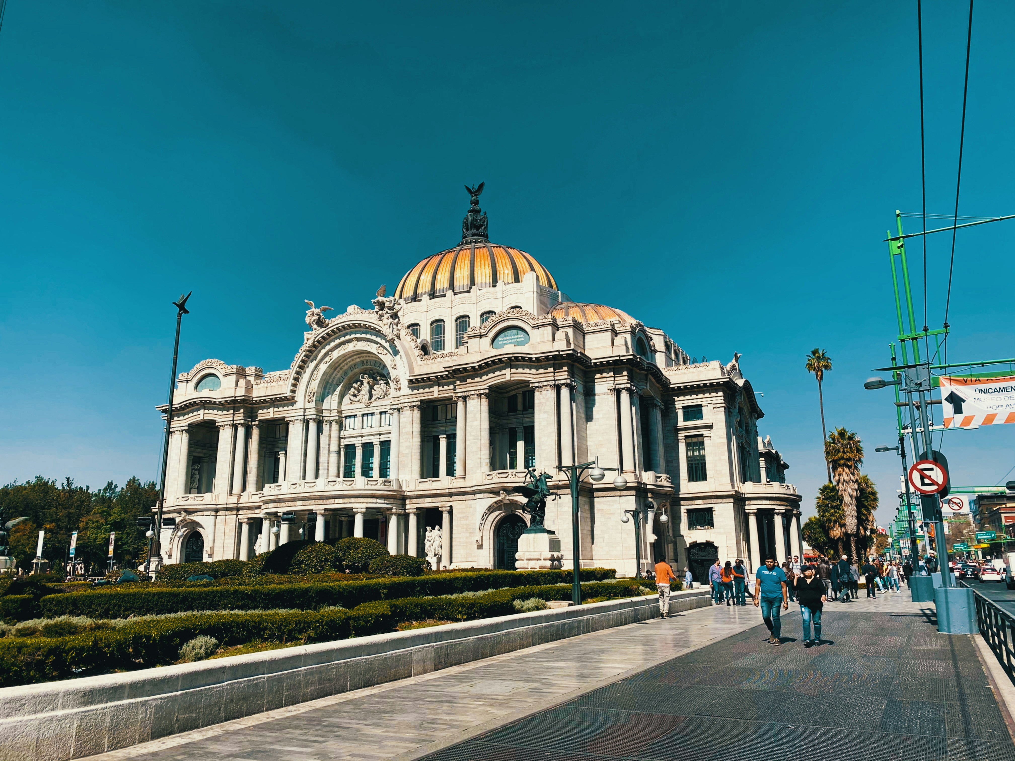 people walking outside dome building