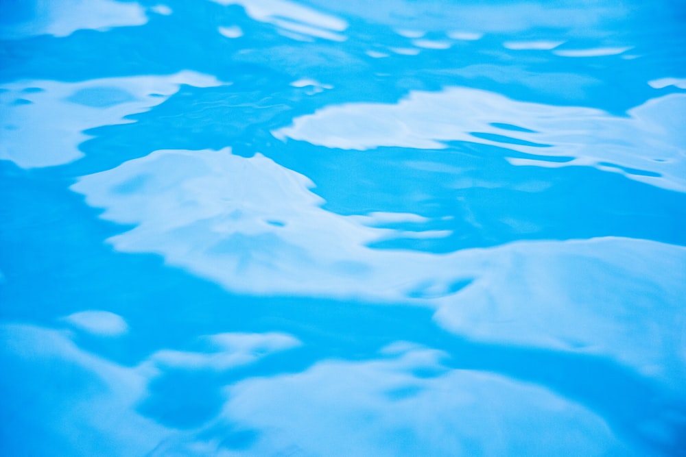 a blue pool of water with white clouds