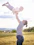 A father and his child share laughter as they play catch together outside on a sunny afternoon.