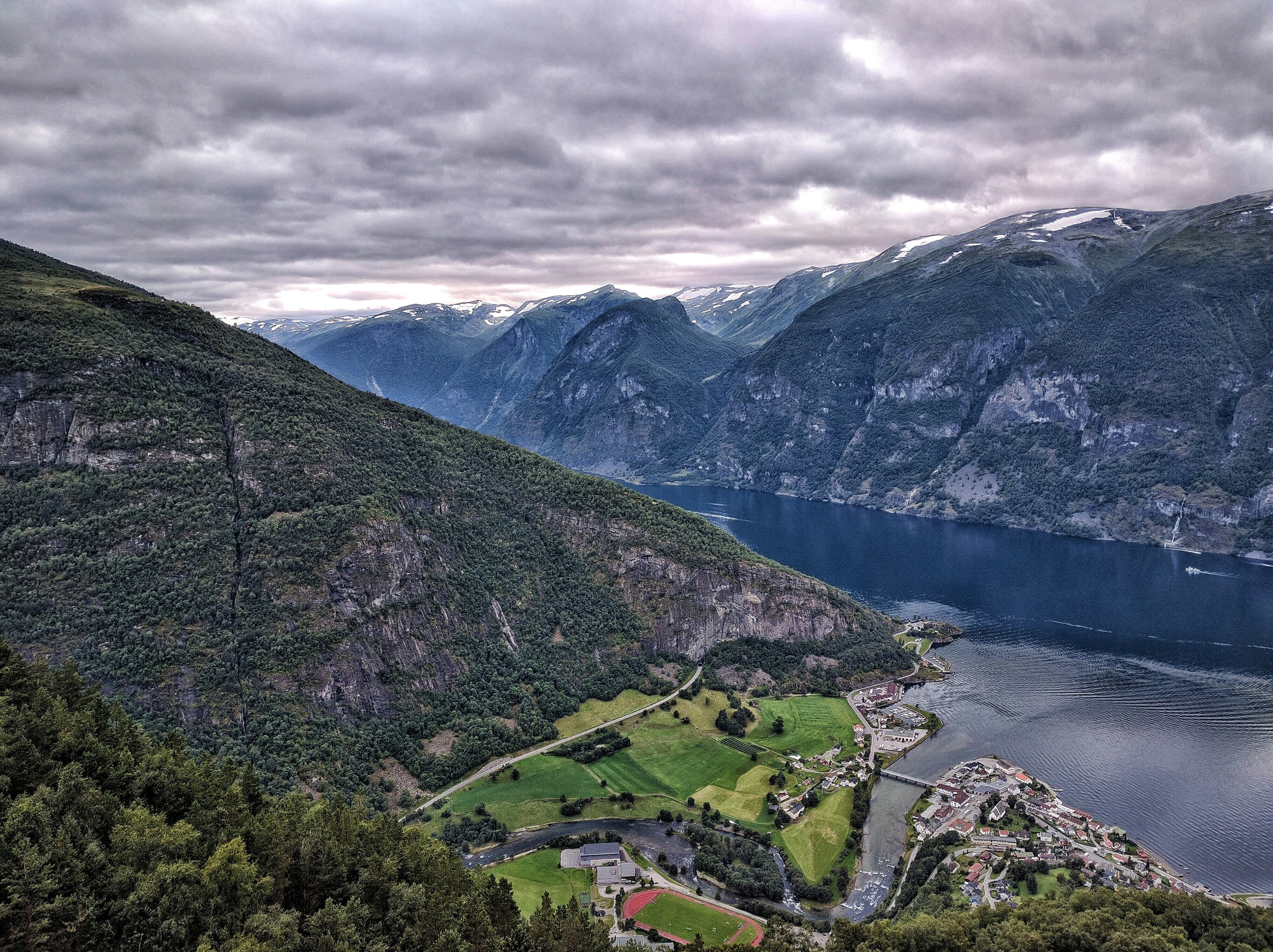 Majestic Scandinavian fjords with snow-capped mountains reflecting in calm waters