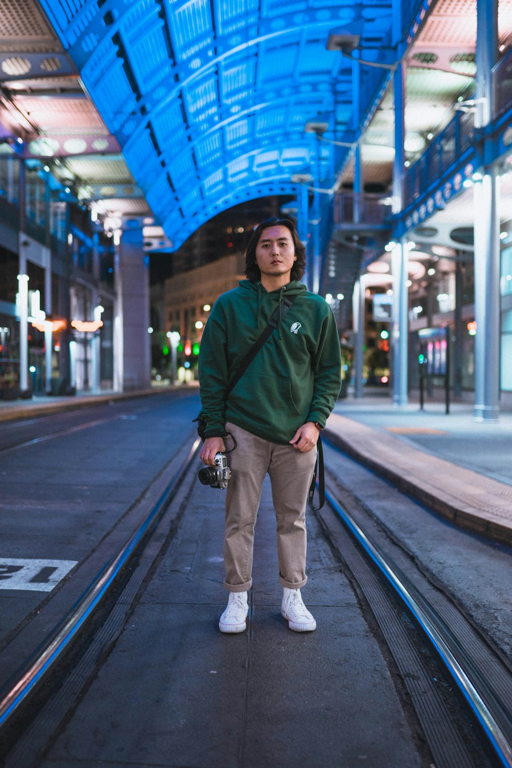 shallow focus photo of man in green pullover hoodie