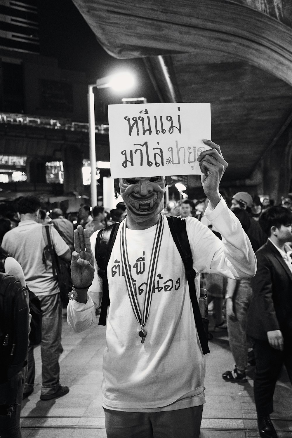 grayscale photo of person holding signage