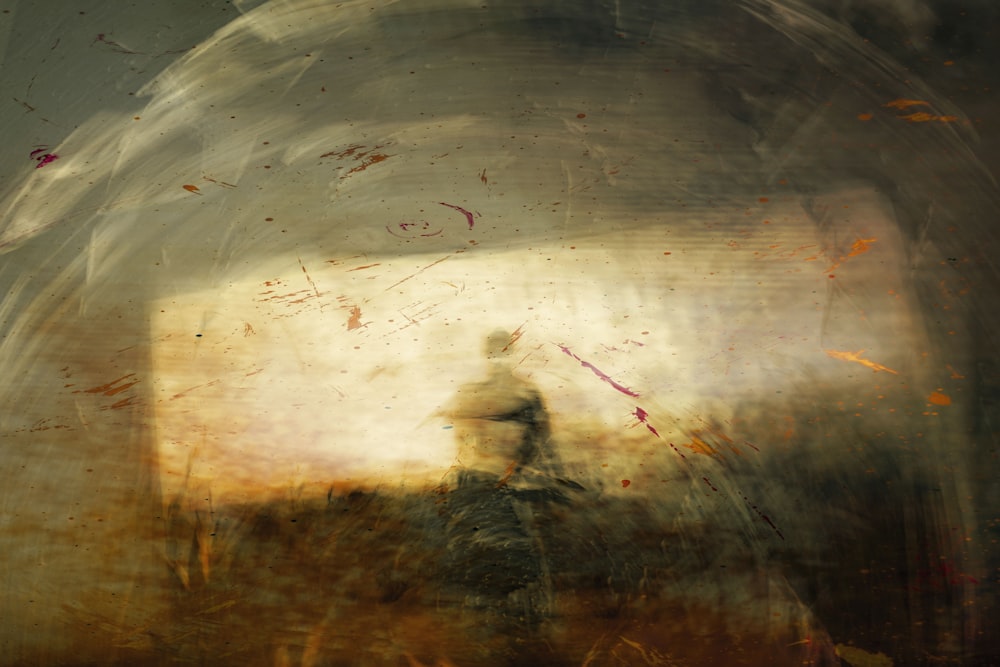un dipinto di una persona in piedi in un campo