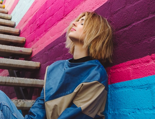 woman leaning on wall