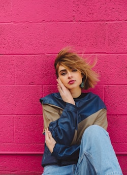 shallow focus photo of woman in navy-blue and brown jacket