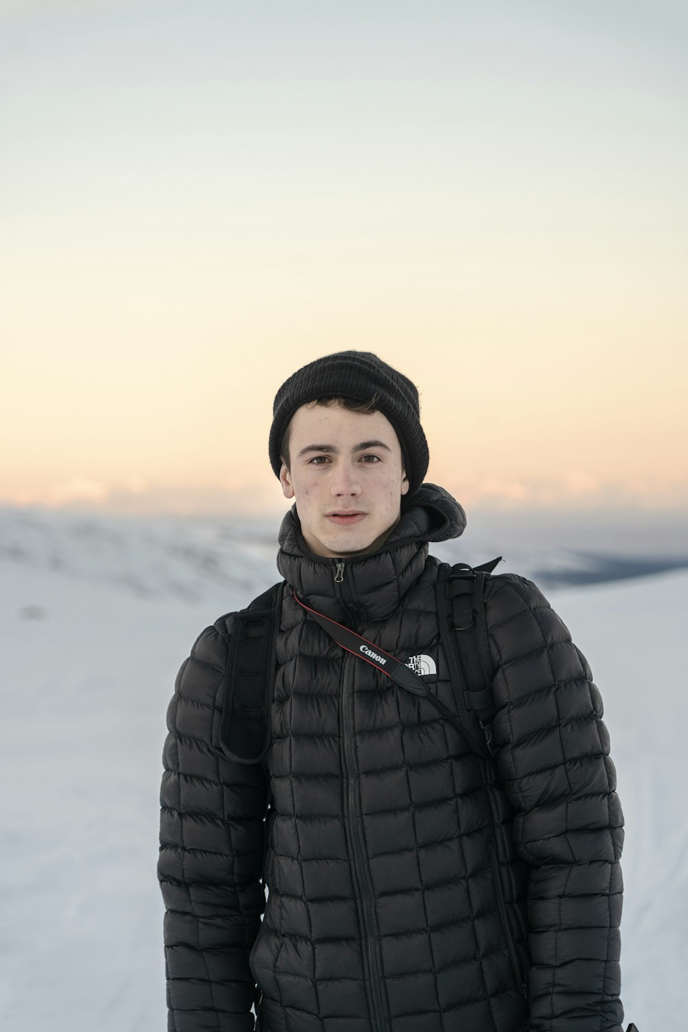 shallow focus photo of man in black The North Face full-zip bubble jacket