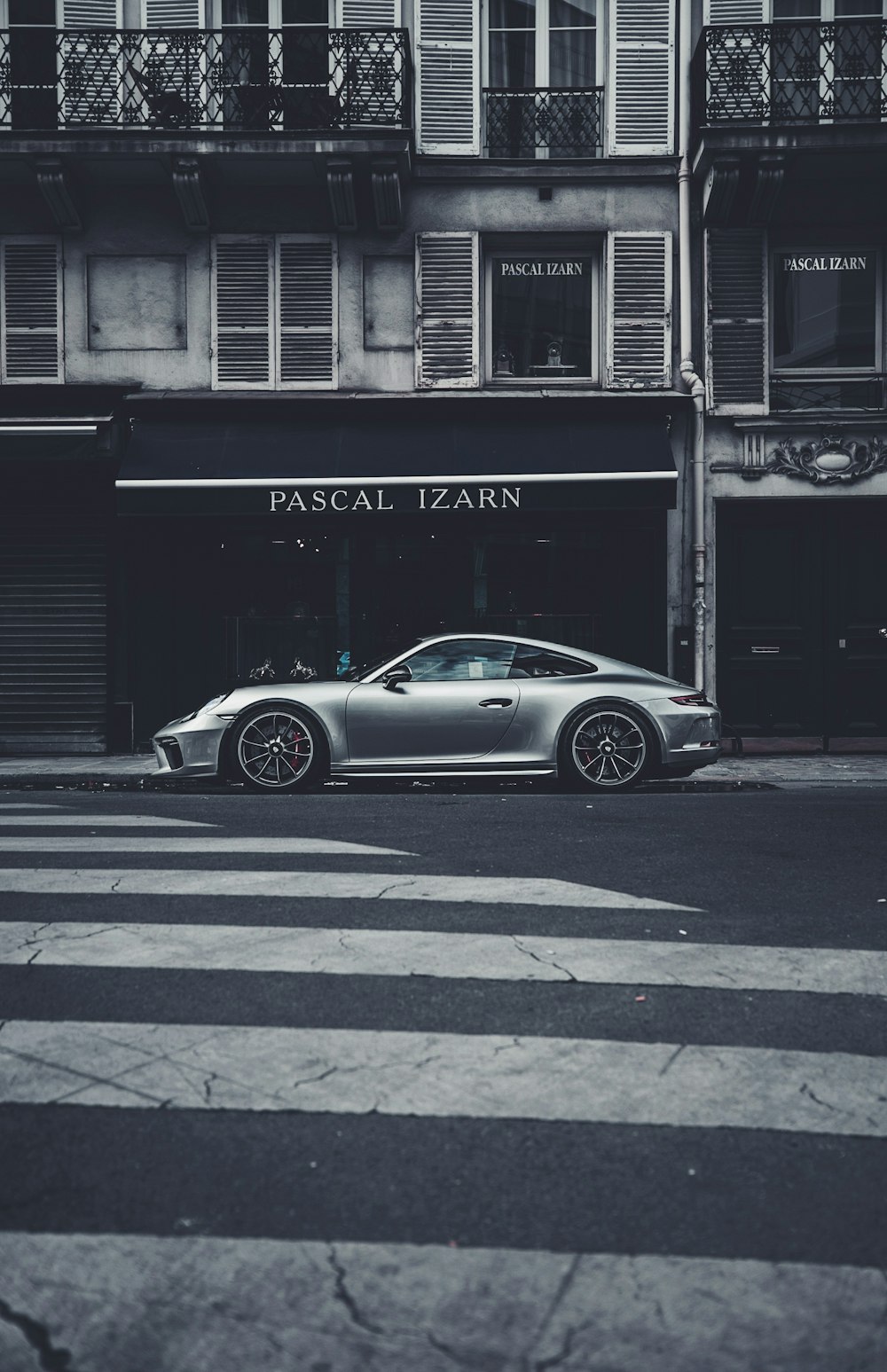 parked coupe on sidewalk