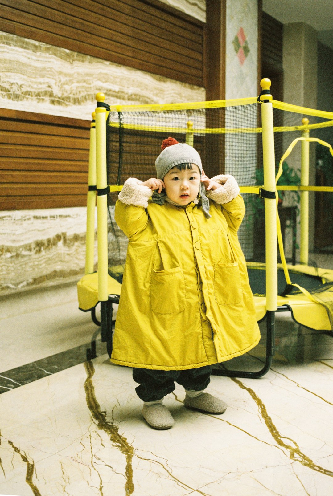 girl wearing yellow jacket and gray bennies