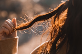 close-up photography of person holding her hair