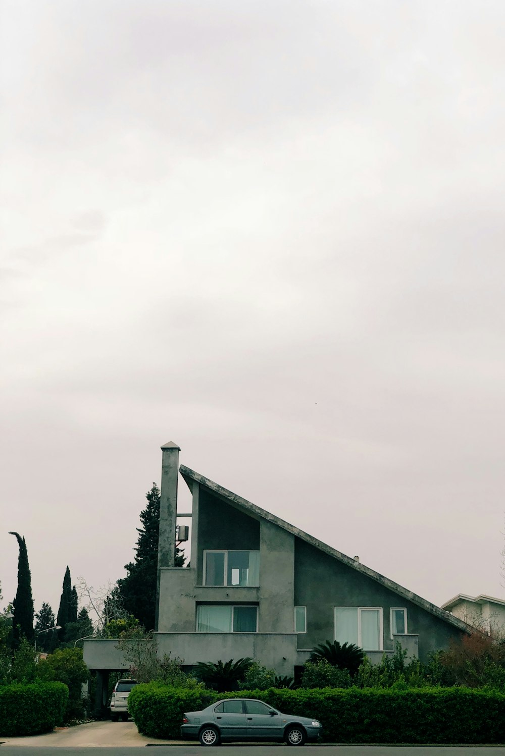 parked gray sedan beside house