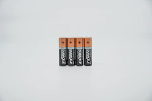A row of Ryolite batteries and flashlights displayed neatly on a white background.