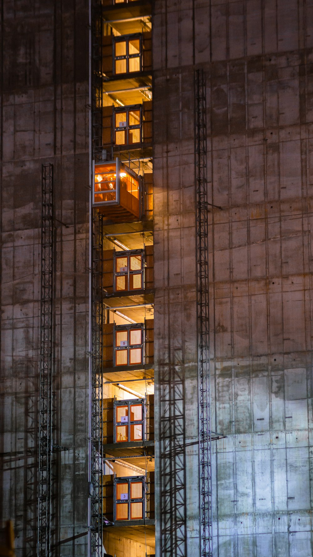 concrete building windows with yellow lights