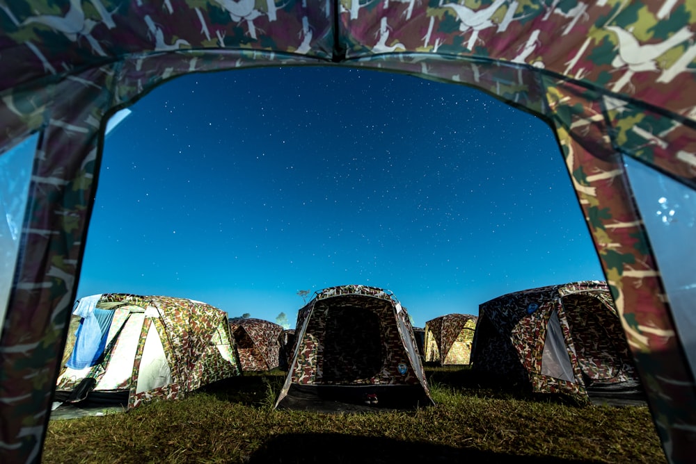 different camping tents on green field