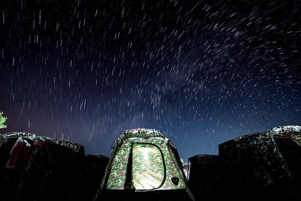 green and brown camouflage tent during nighttime