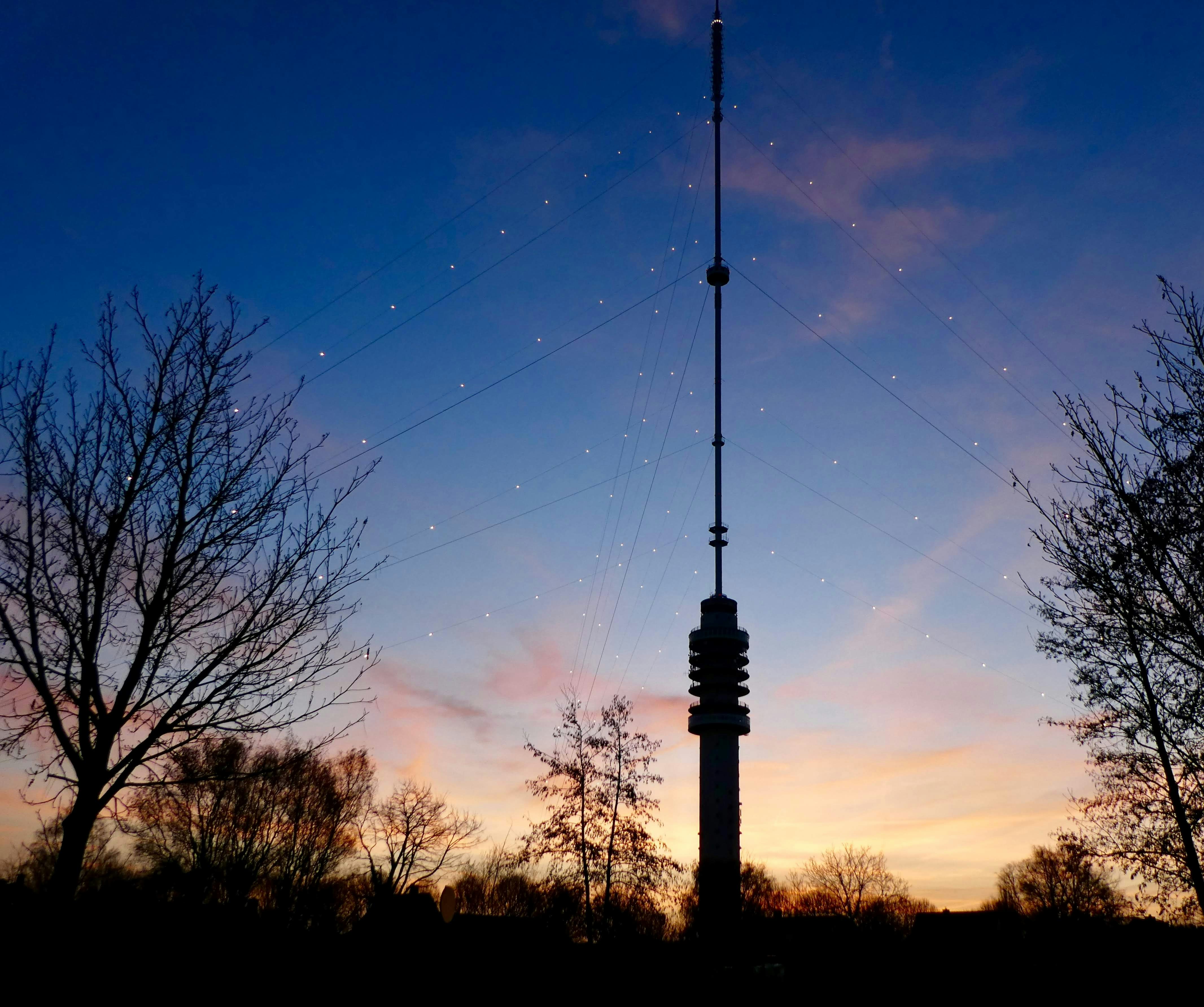 Radio tower with colorful light trails