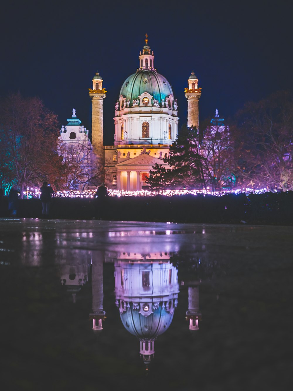 lighted dome building and trees near river during nighttime