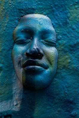 A close-up of a textured wall sculpture in calming blue tones.