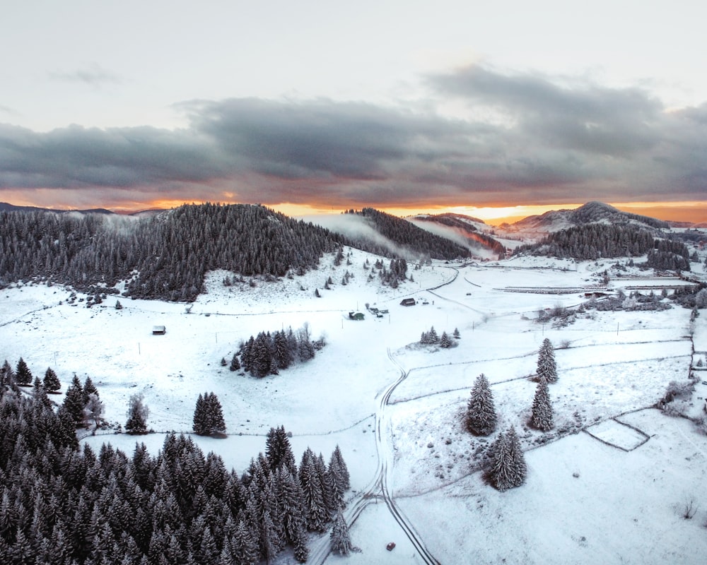 snow covered mountains under cloudy sky