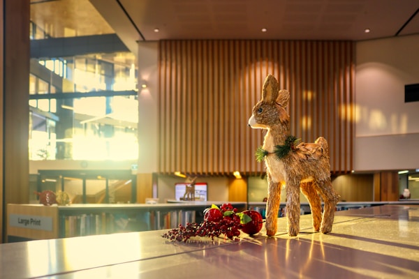 Cheerful reindeer ornaments made from eco-friendly materials, displayed on a rustic wooden table.