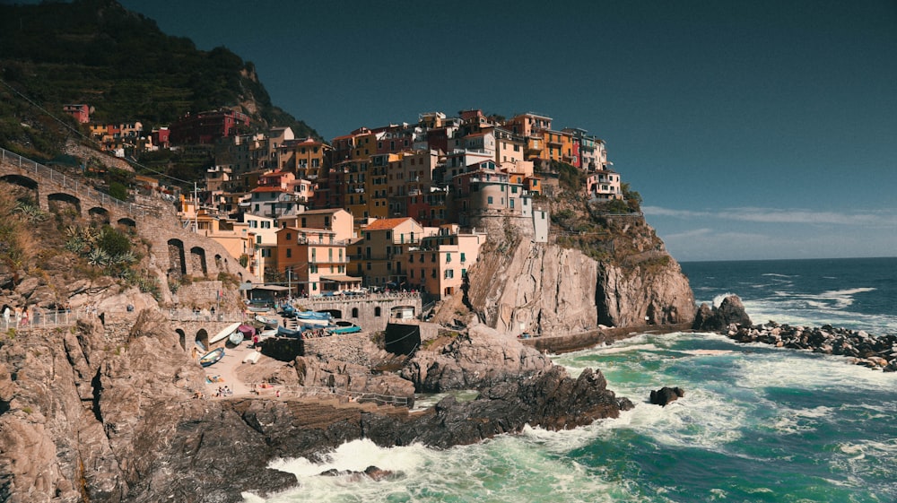 buildings on cliff near ocean during daytime