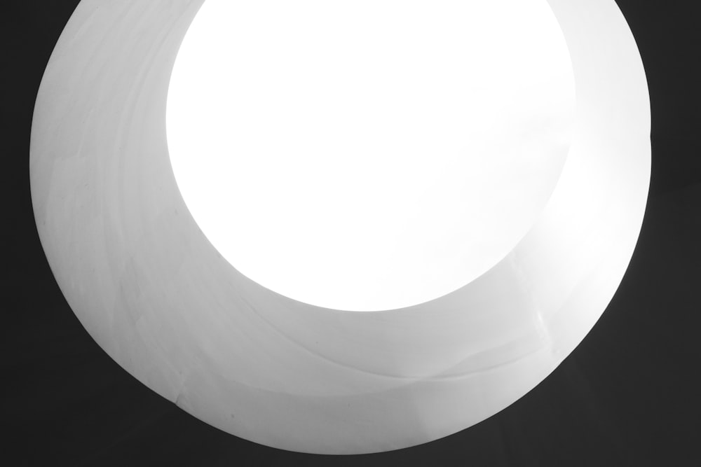 a white circular object with a black background
