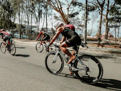 three cyclists on road
