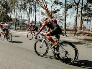 three cyclists on road