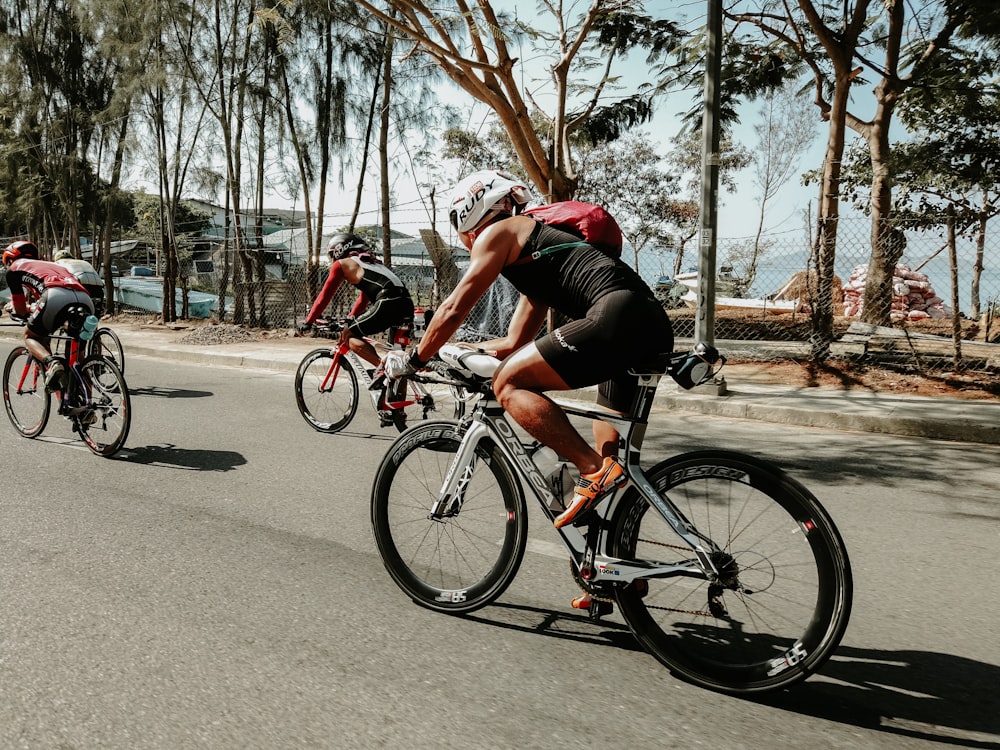 three cyclists on road