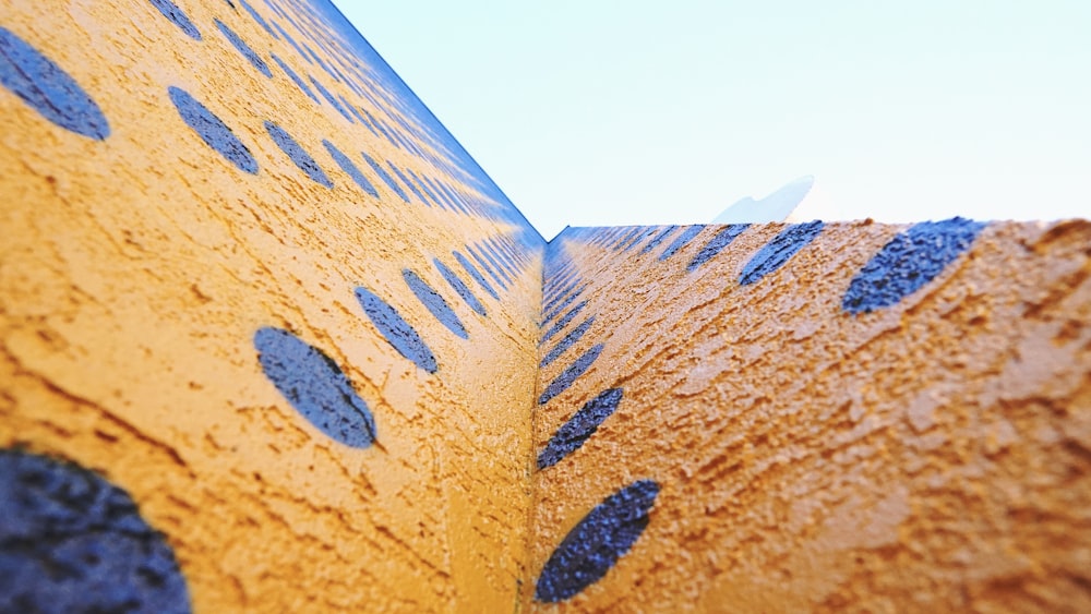 low-angle photography of orange and blue concrete wall