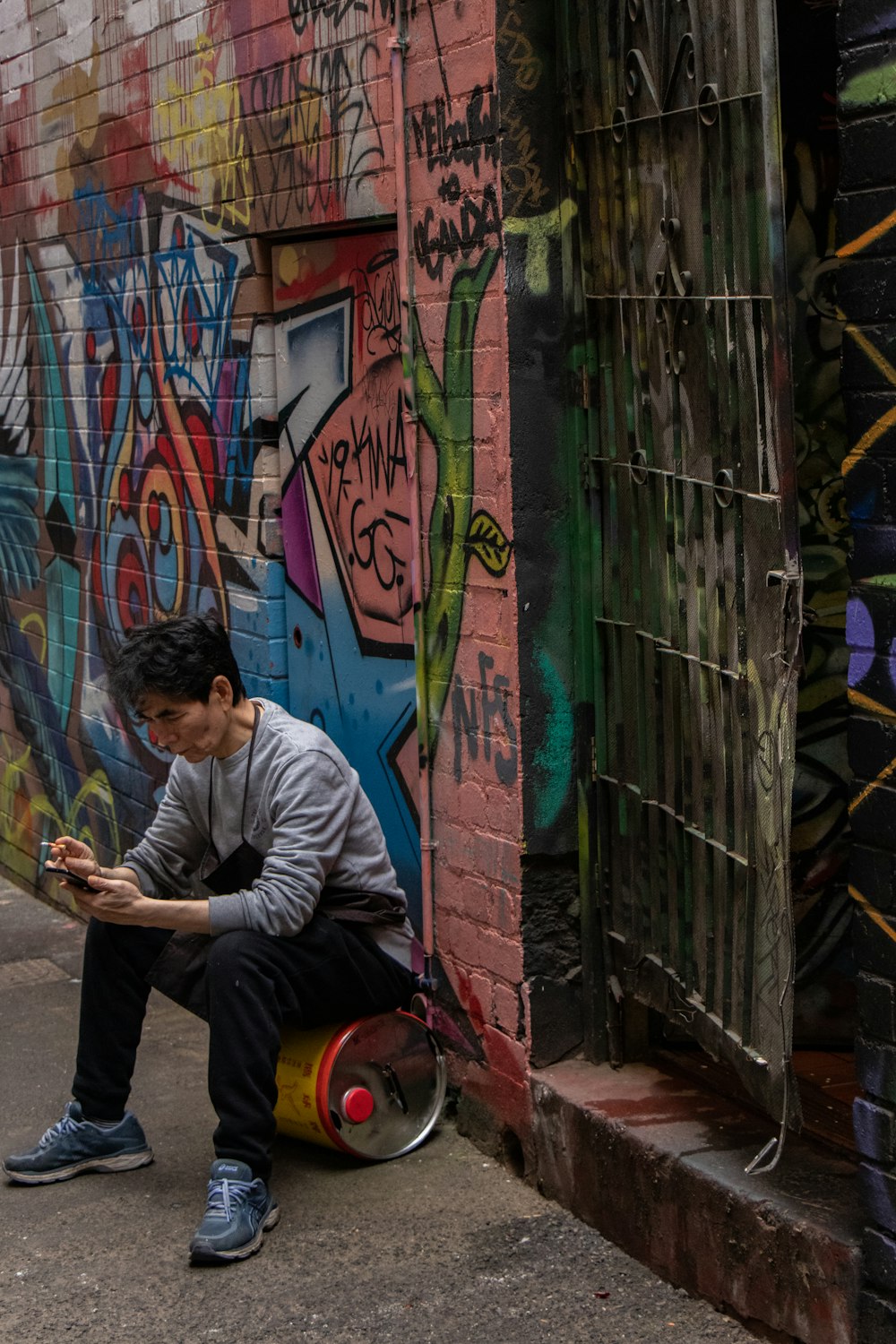 man sitting on oil can